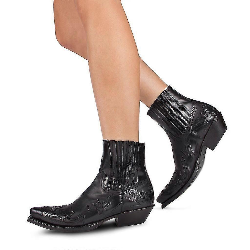 Black inlay western ankle boots worn walking