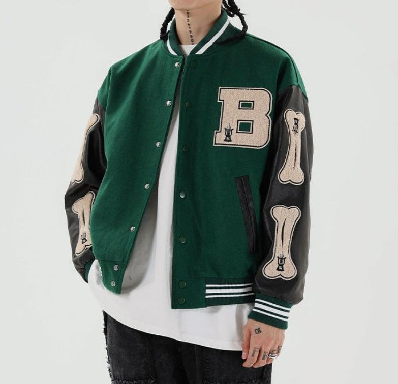 Green varsity bomber with patches worn, front