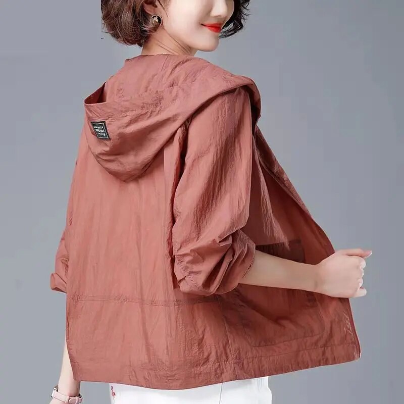 Rust hooded lightweight jacket worn, back view