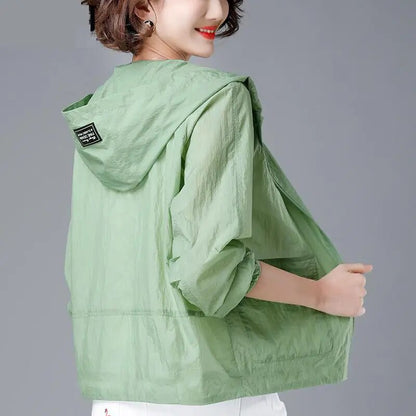 Green lightweight hooded jacket worn, back view