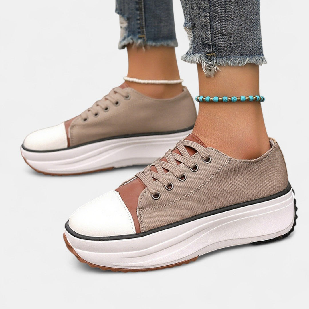 Brown low top platform sneakers with white toe cap worn with cropped jeans