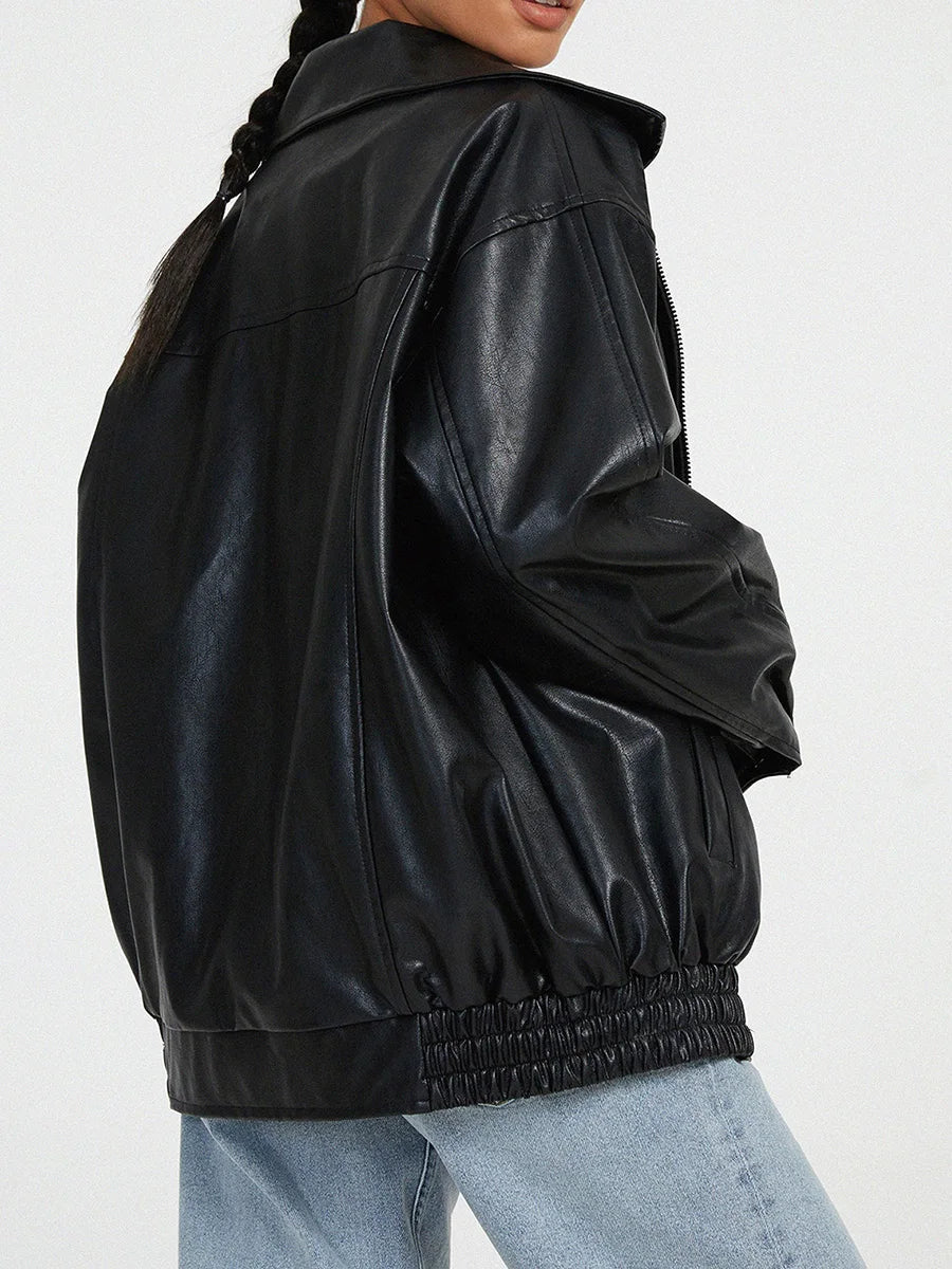 Black oversized bomber jacket from the side showing the gathered hem
