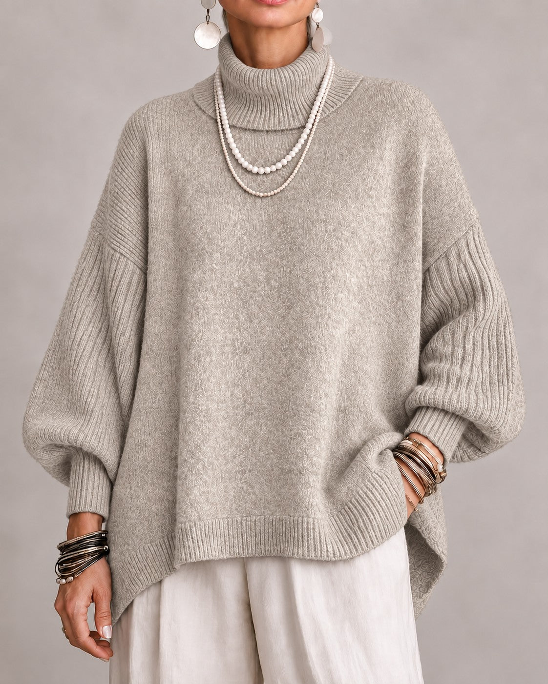 Beige oversized turtleneck sweater with ribbed balloon sleeves, front view