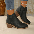 Gray perforated panel ankle boots worn with cropped jeans, side view