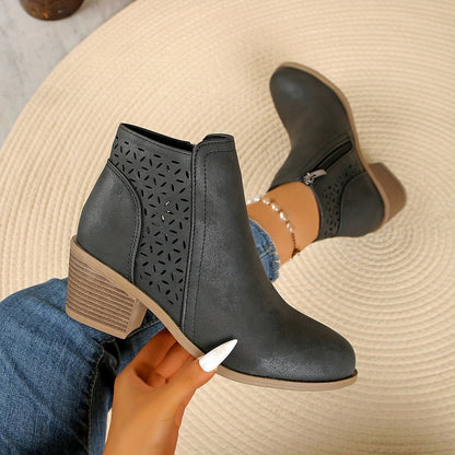 Gray perforated panel ankle boots held up, side and zip view
