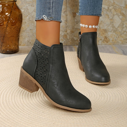 Gray perforated panel ankle boots worn with cropped jeans, angled view