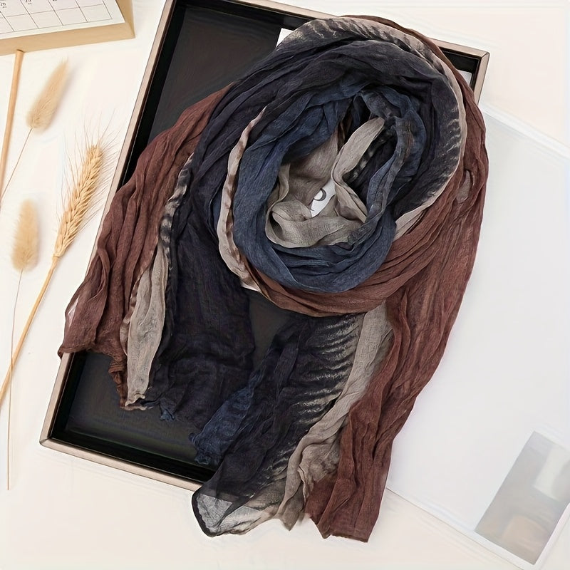 Navy and brown pleated gradient scarf laid on a tray