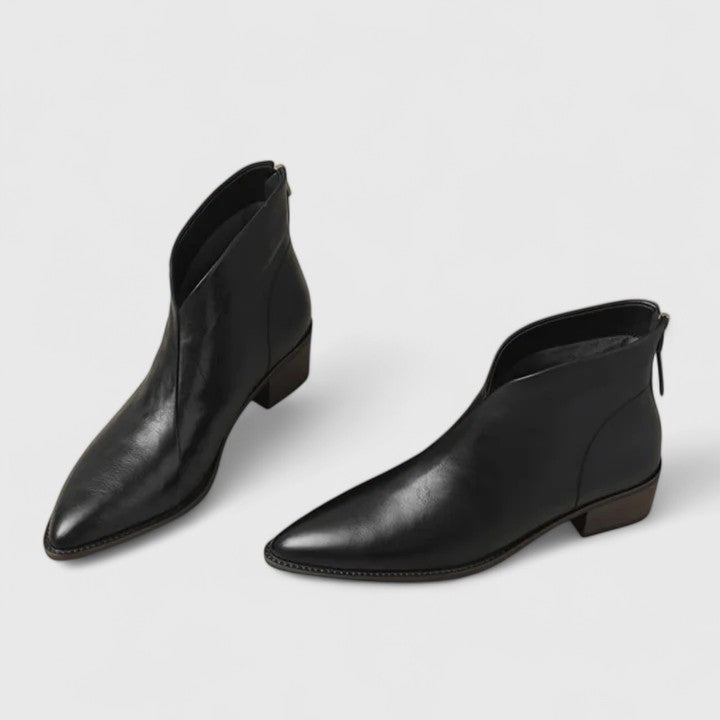 Pair of black pointed toe ankle boots with a V cut topline and block heels, studio view