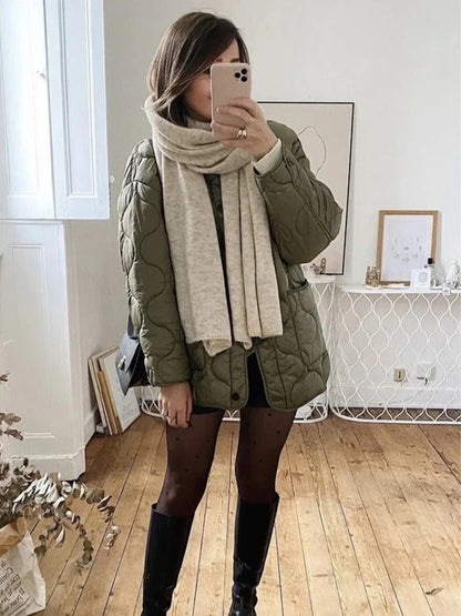Green quilted collarless jacket styled with a knit scarf and knee high boots, mirror view