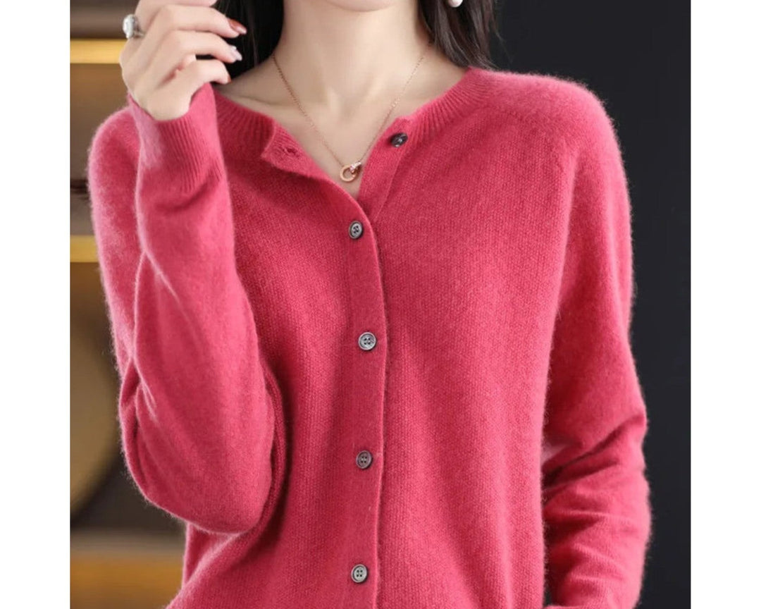 Rose red crew neck cardigan worn with light pants, front view