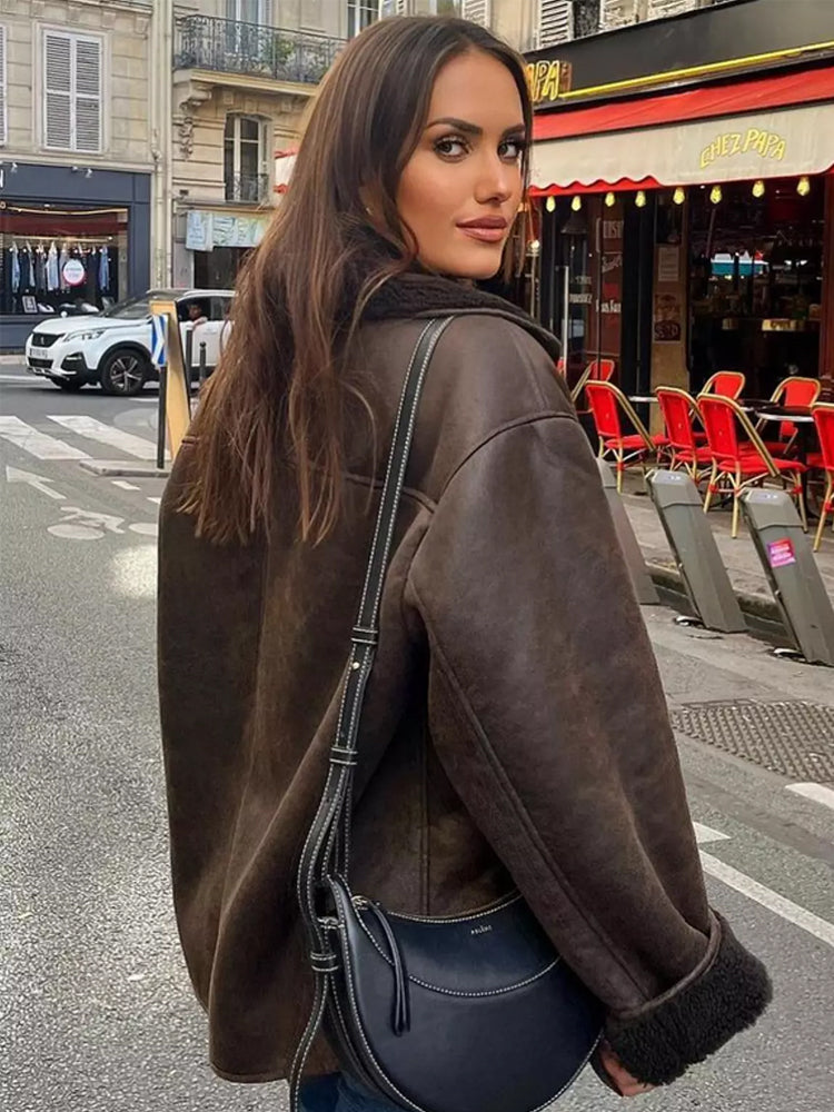 Brown relaxed lapel jacket seen from the back on a city street