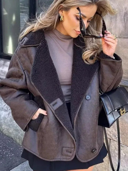 Brown relaxed jacket with wide lined lapel collar worn over a turtleneck