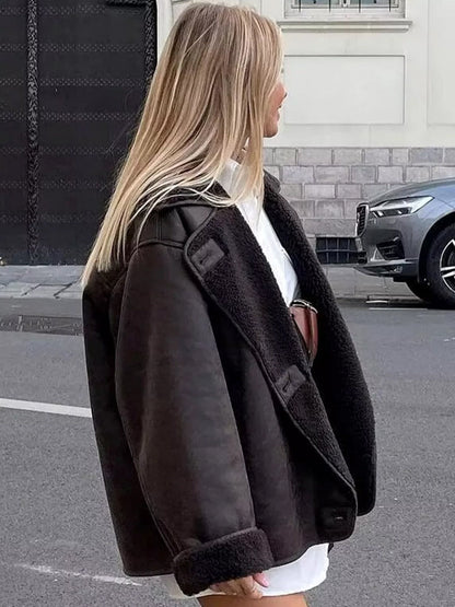 Brown relaxed lapel jacket shown from the side with turned-back cuffs