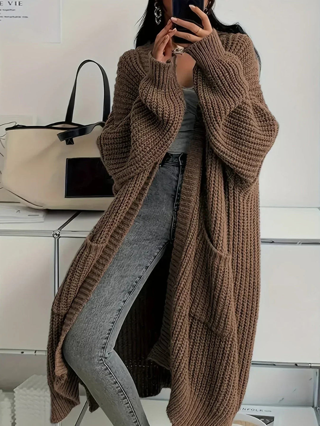 Brown rib knit duster cardigan worn open over jeans
