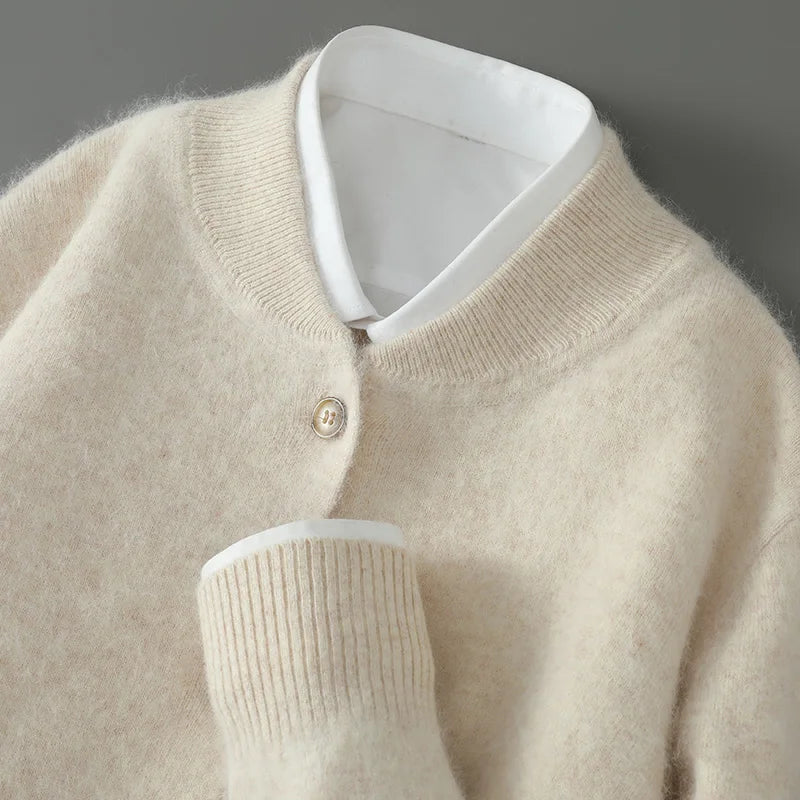 Beige knit cardigan close-up of the ribbed neckline and cuff over a white shirt