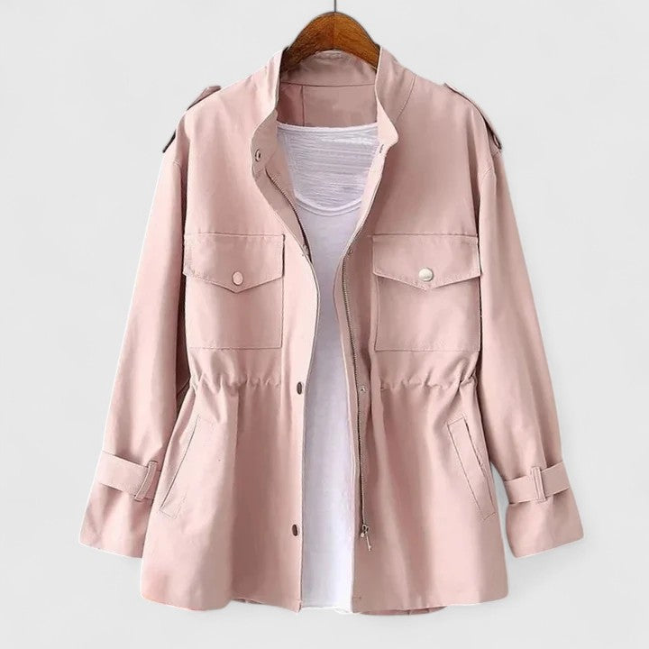 Pink safari utility jacket on a wooden hanger, front view