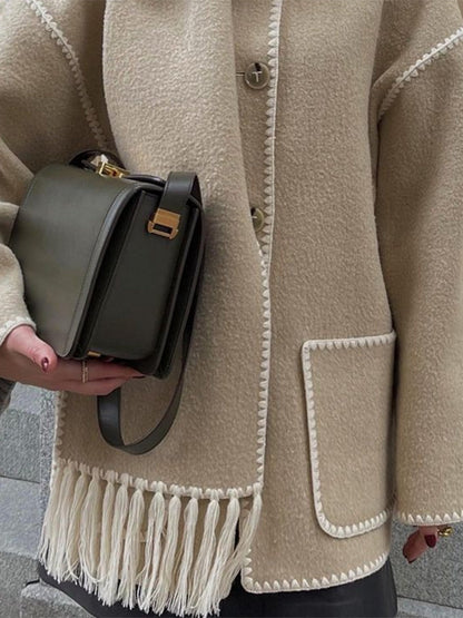 Close up of the beige scarf coat fringe and patch pocket