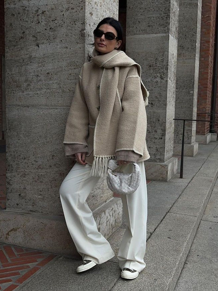 Beige scarf wrap coat worn with white pants