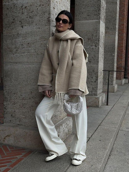 Beige scarf wrap coat worn with white pants