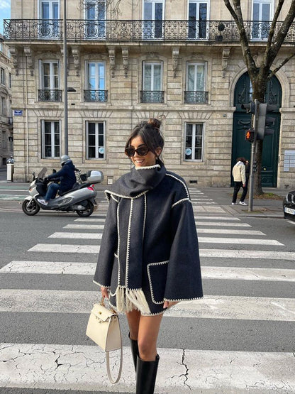Charcoal scarf wrap coat worn with knee boots on the street