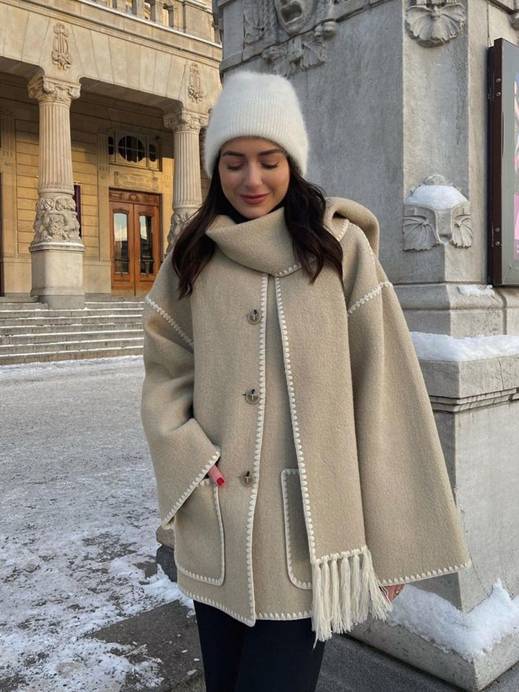 Beige scarf wrap coat worn with a knit beanie in winter