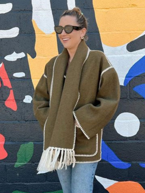 Olive green fringed scarf wrap coat worn with jeans