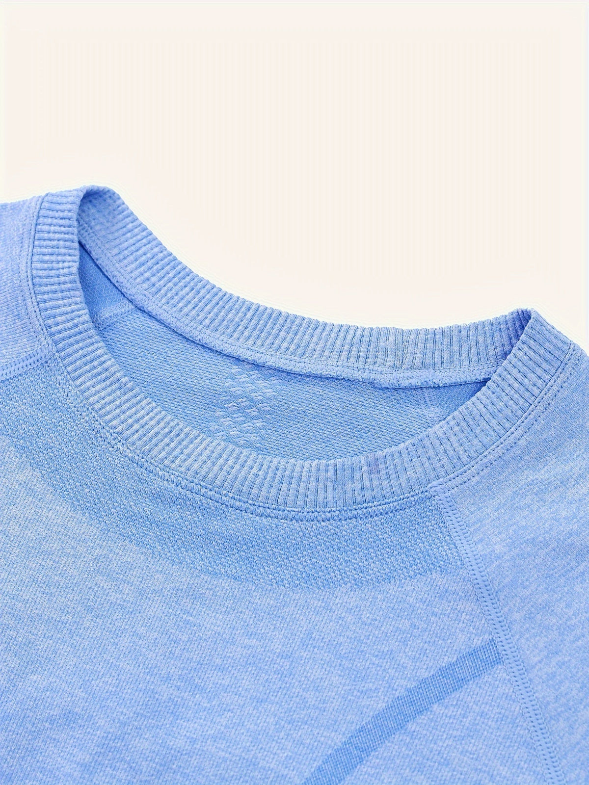 Close up of the blue seamless knit crew neckline