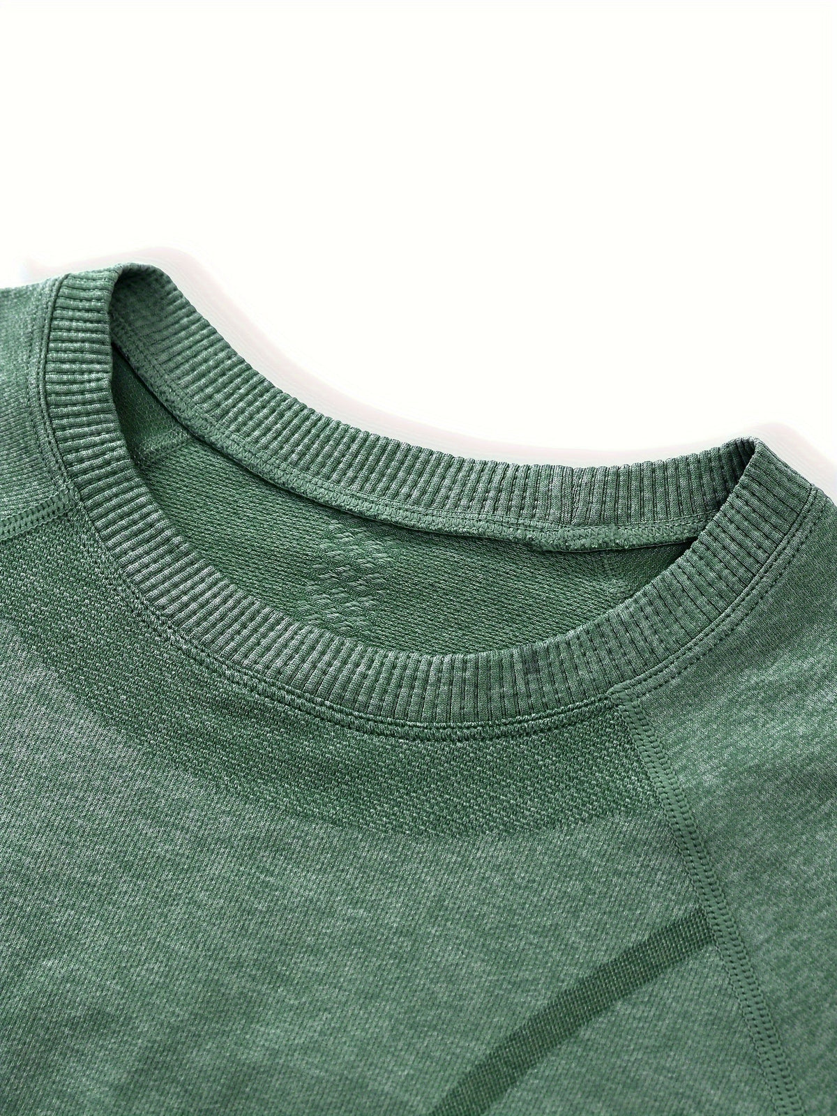 Close up of the green seamless knit crew neckline
