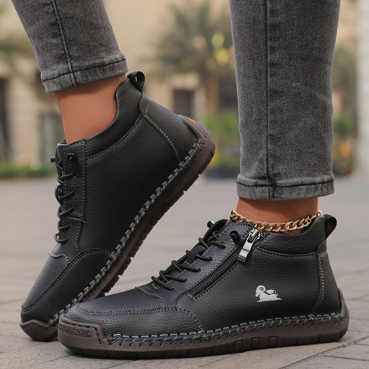 Women's lace-up side zip sneakers in black, side view showing the zip