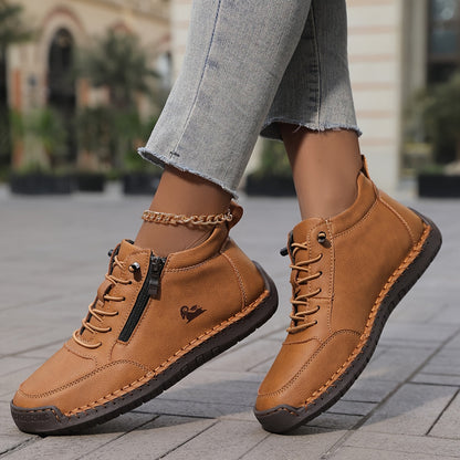 Women's lace-up side zip sneakers in tan, side view on a paved street