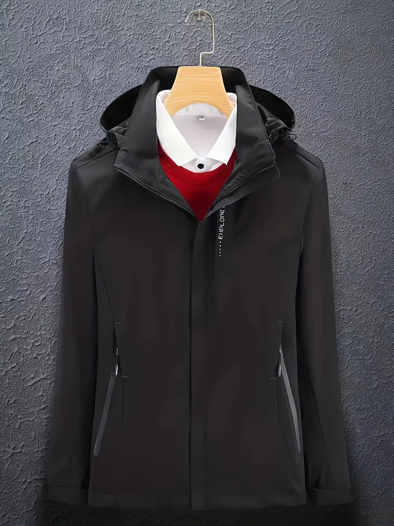 Black soft shell hooded jacket on a hanger