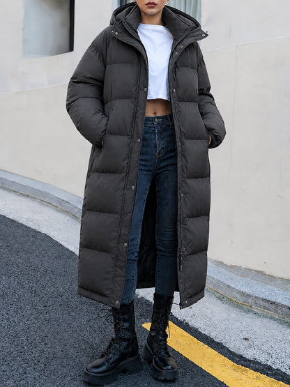 Black long puffer coat with stand collar, worn closed, front view