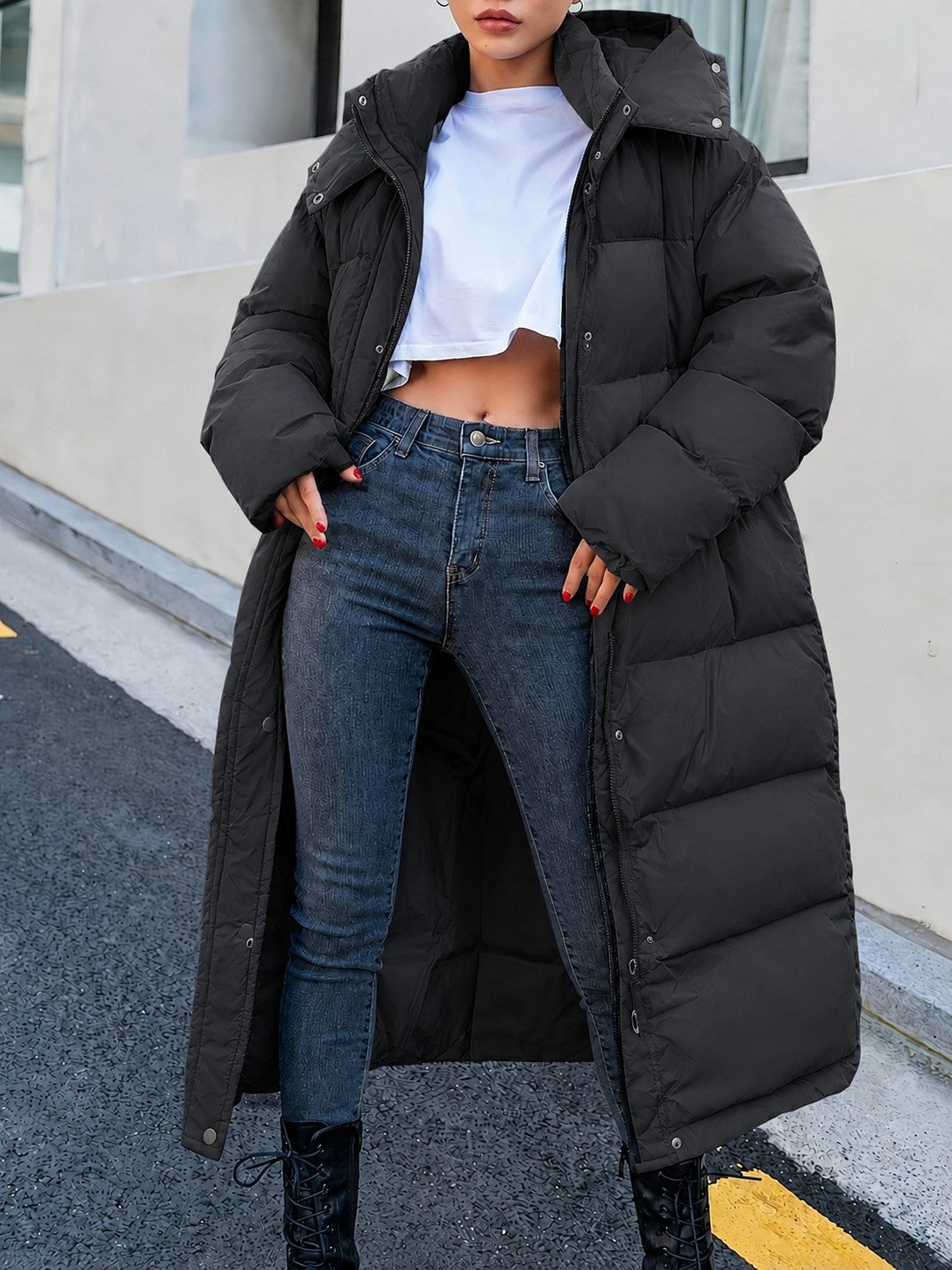 Black hooded maxi puffer coat worn open over jeans