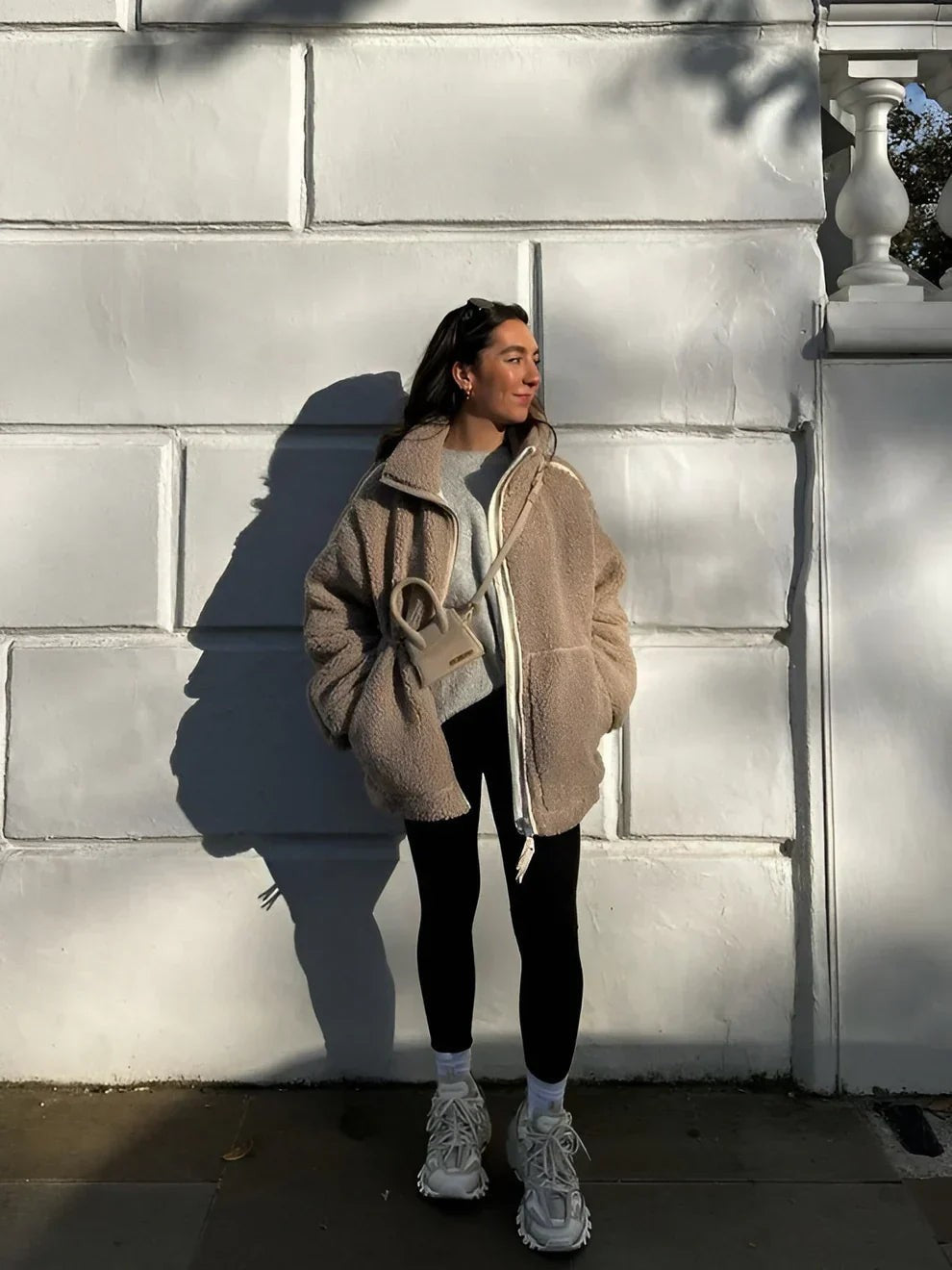 Oatmeal teddy fleece jacket worn with leggings outdoors