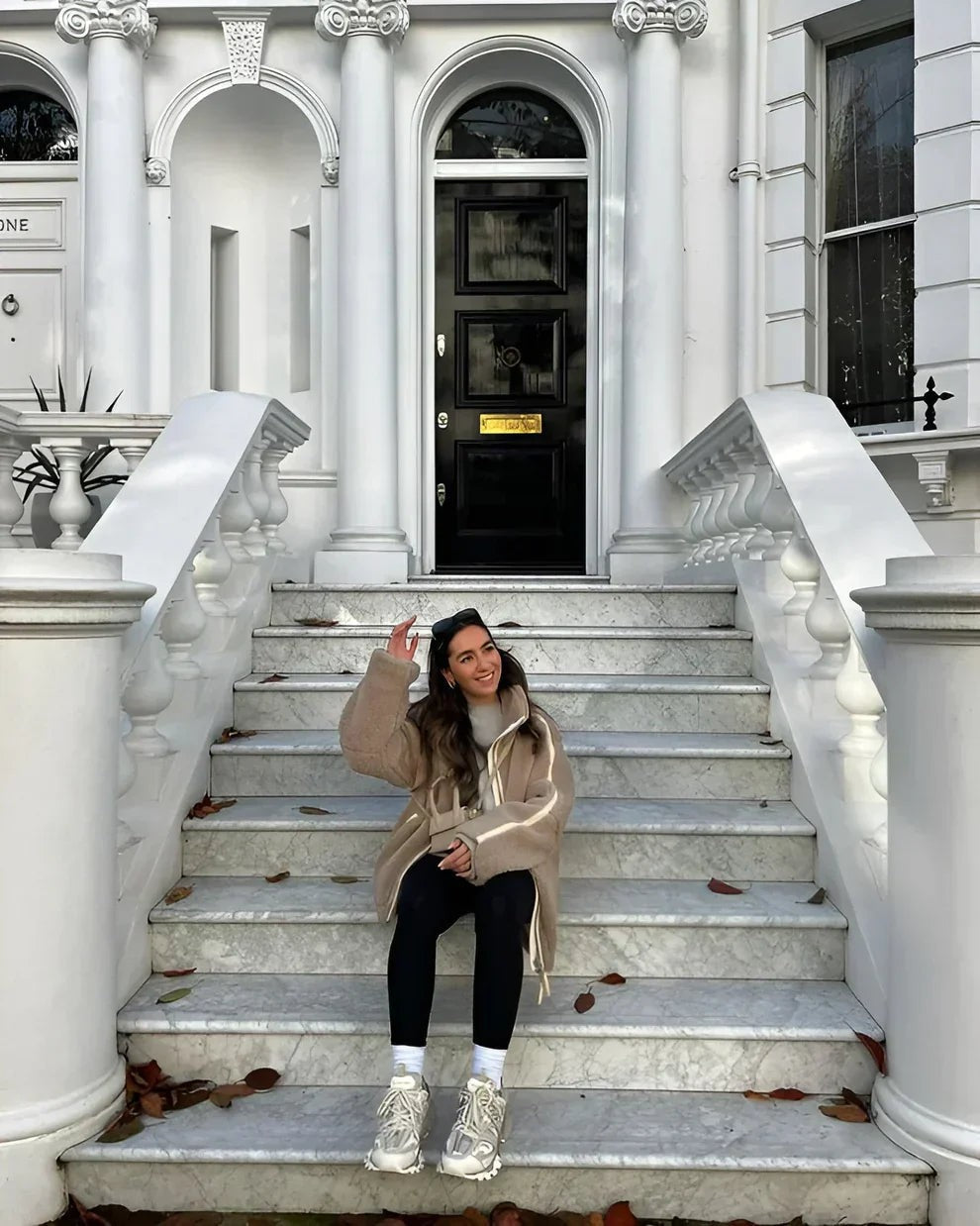 Teddy fleece jacket worn on stone steps with leggings