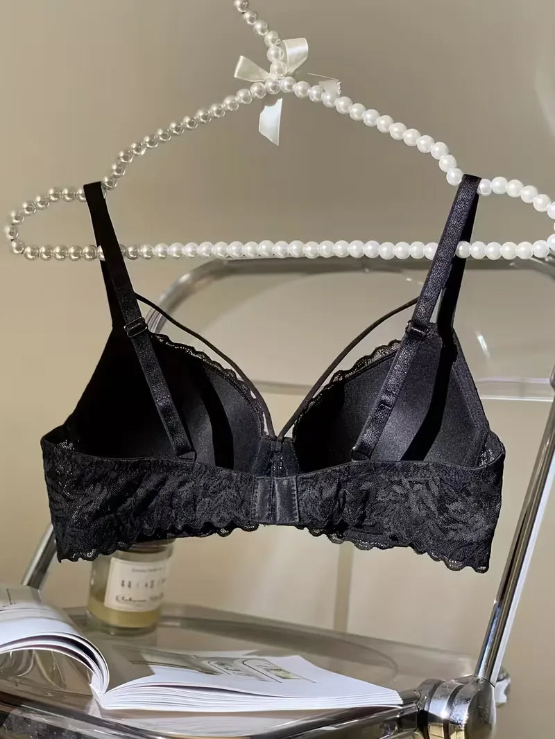Inside view of the black strappy lace bra on a hanger