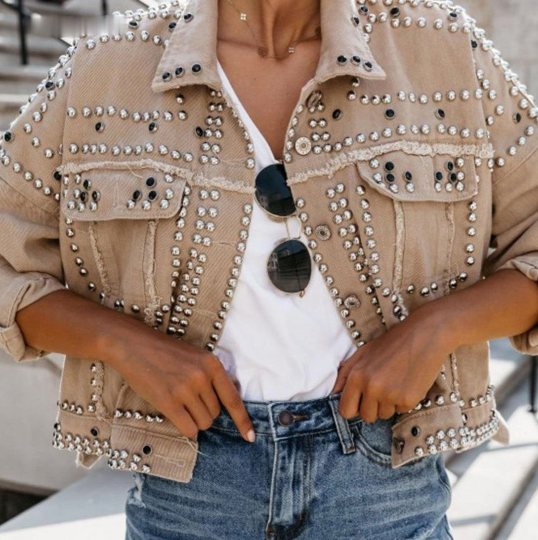 Beige studded cropped denim jacket worn, front
