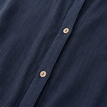 Wooden buttons down the front of a navy cotton jacket