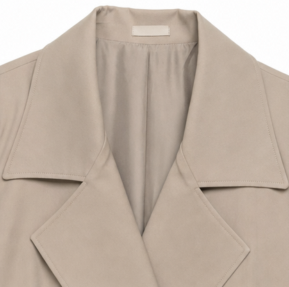 Close up of the notch lapel and storm flap on a taupe trench coat