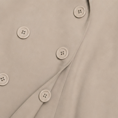 Double breasted button detail on a taupe trench coat