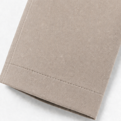 Stitched cuff detail on a taupe trench coat sleeve