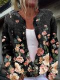 Black button front cardigan with a pink and cream floral border print, worn open over a white top