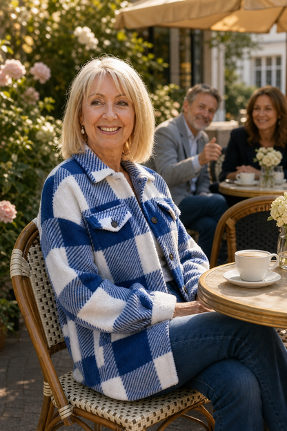 Woman at an outdoor cafe in a blue buffalo check sherpa overshirt