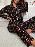 Black button up pajama set with a red candy cane and white snowflake print