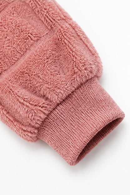 Ribbed cuff on a dusty pink checkered plush cardigan sleeve