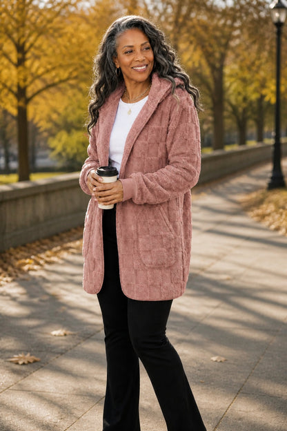Dusty pink plush hooded cardigan on an autumn street