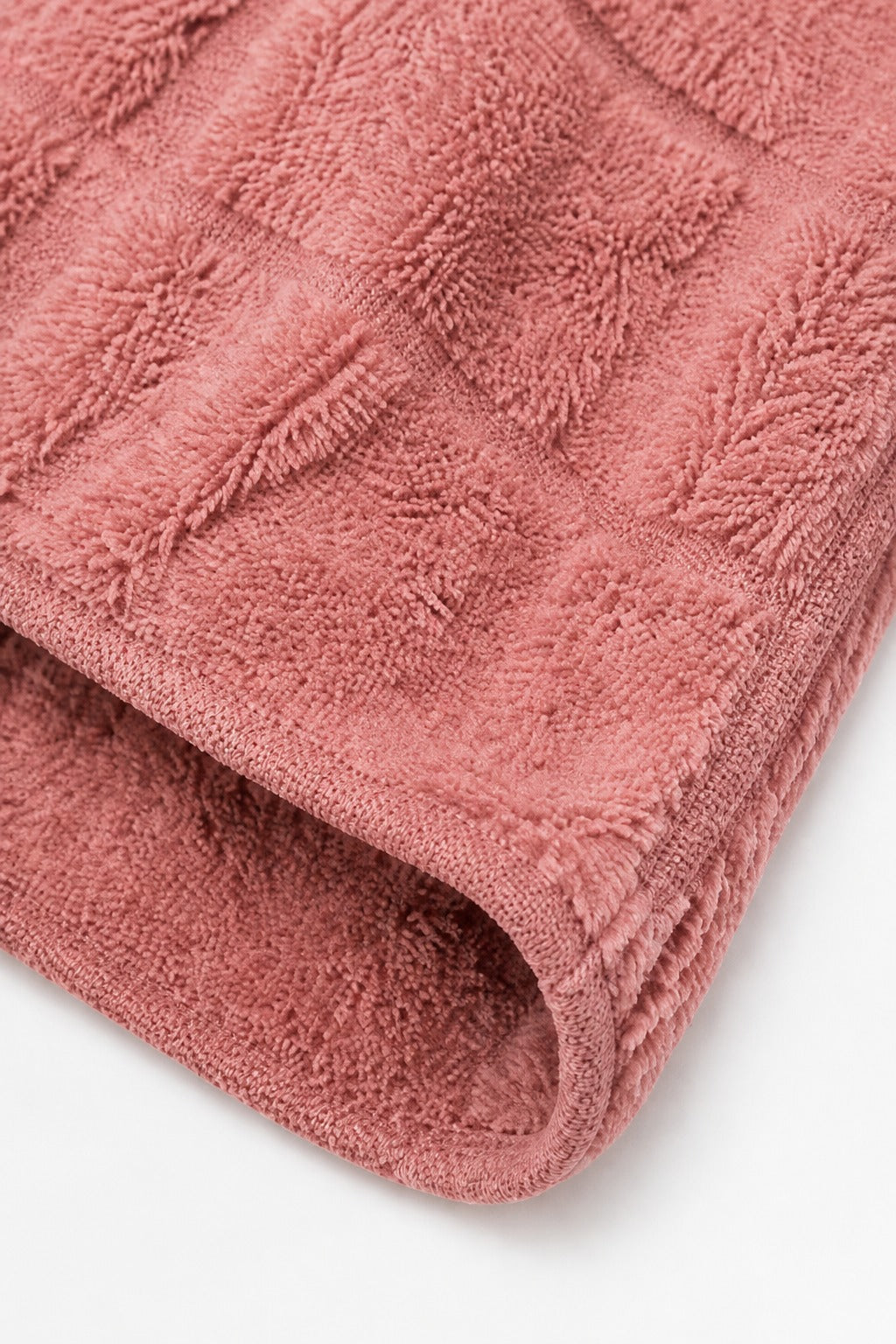Folded sleeve hem on a dusty pink checkered plush cardigan