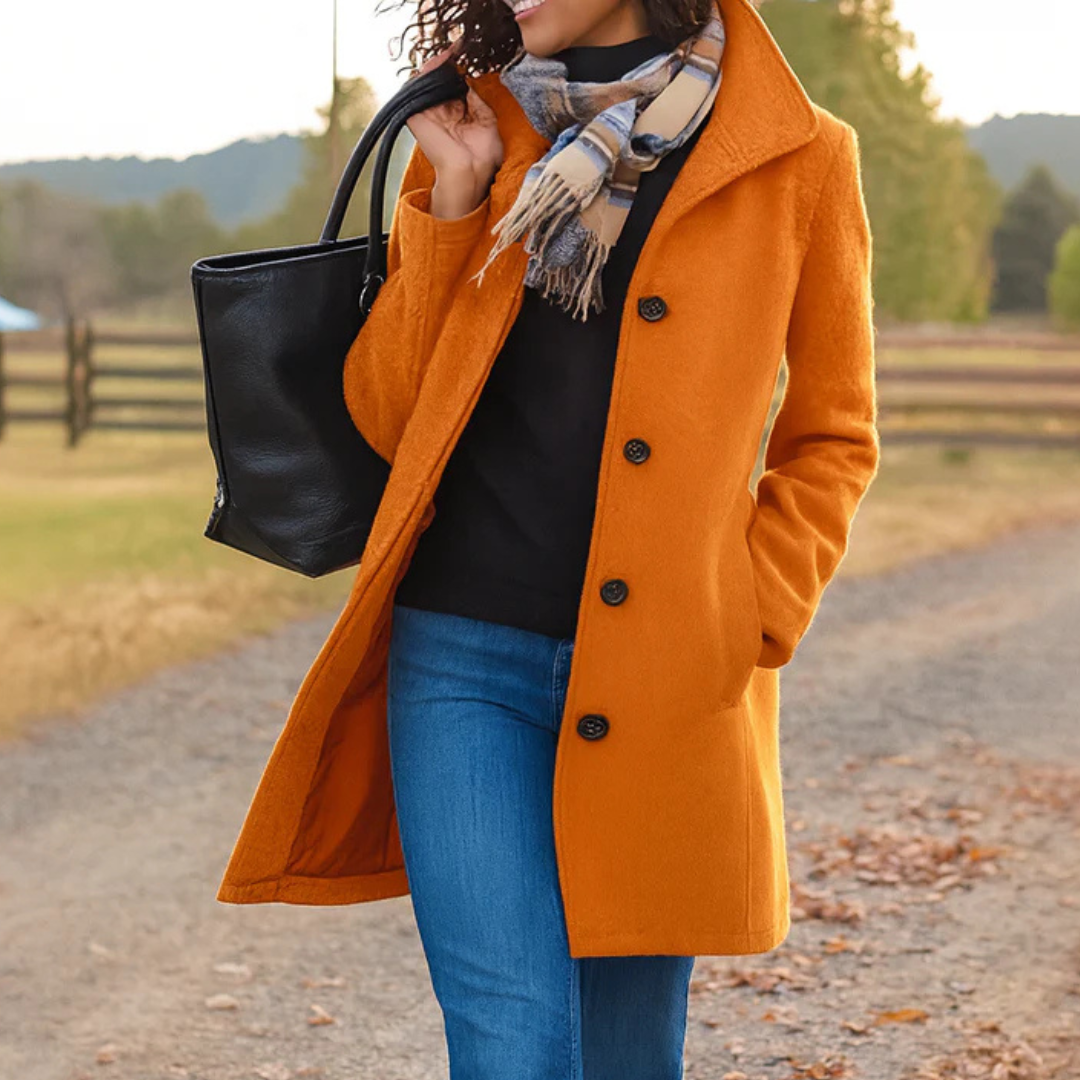 Orange button-front longline winter coat worn with jeans