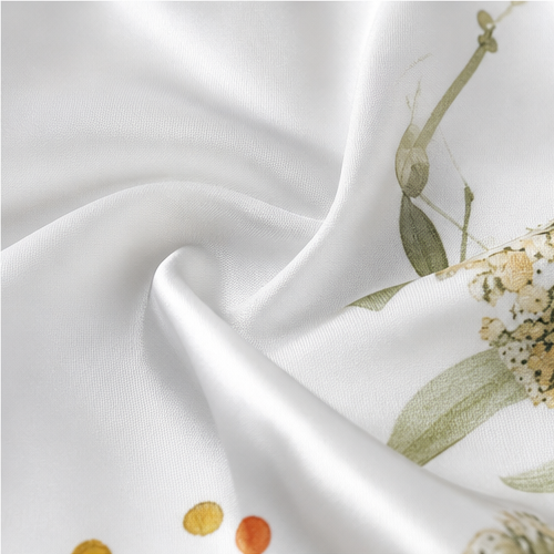Close-up of the floral print on white satin in soft folds