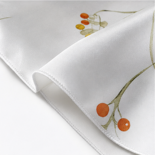 Rolled hem on white satin printed with berries and leaves